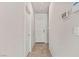 Neutral hallway with tile flooring and white doors, providing access to different areas at 7819 Rachelis St, North Las Vegas, NV 89084