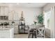 Kitchen featuring granite counters, stainless appliances, and a gray dining table at 7819 Rachelis St, North Las Vegas, NV 89084