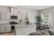 Modern kitchen with stainless steel appliances, granite countertops, and a cozy dining area at 7819 Rachelis St, North Las Vegas, NV 89084