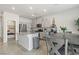 Bright kitchen with granite countertops, stainless steel appliances, and gray dining table at 7819 Rachelis St, North Las Vegas, NV 89084