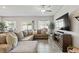 Spacious living room with tile floors, stylish sectional, and plenty of natural light at 7819 Rachelis St, North Las Vegas, NV 89084