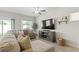 Bright living room with a large comfortable couch, entertainment center and neutral decor at 7819 Rachelis St, North Las Vegas, NV 89084