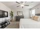 Comfortable main bedroom with ceiling fan, TV, and dresser, perfect for rest at 7819 Rachelis St, North Las Vegas, NV 89084