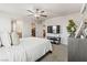 Serene main bedroom with plush bedding, ceiling fan, and ensuite bathroom for relaxation at 7819 Rachelis St, North Las Vegas, NV 89084