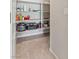 Pantry with tile floor and shelving with ample storage for kitchen items at 7819 Rachelis St, North Las Vegas, NV 89084