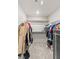 A walk-in closet with clothes hanging on rods and shelves for organization at 7819 Rachelis St, North Las Vegas, NV 89084