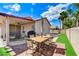 Charming backyard patio with dining set, BBQ grill, and artificial turf, perfect for entertaining at 8250 Lincoln Valley St, Las Vegas, NV 89123