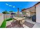 Relaxing backyard oasis with covered patio, dining set, and swing for outdoor enjoyment at 8250 Lincoln Valley St, Las Vegas, NV 89123
