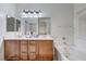 Bathroom featuring a double sink vanity, soaking tub, and large mirrors at 8250 Lincoln Valley St, Las Vegas, NV 89123