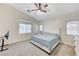 The main bedroom features carpet, a ceiling fan, and ample natural light at 8250 Lincoln Valley St, Las Vegas, NV 89123