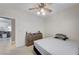 Cozy bedroom with a ceiling fan, carpet, and a view into the living area at 8250 Lincoln Valley St, Las Vegas, NV 89123