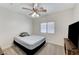 Bedroom features a ceiling fan, plush carpet, and a large window for natural light at 8250 Lincoln Valley St, Las Vegas, NV 89123