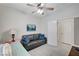 Cozy bedroom featuring a ceiling fan, twin bed and comfortable sitting area at 8250 Lincoln Valley St, Las Vegas, NV 89123