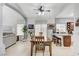 Open-concept dining area features a long table, chairs, tiled floor, and lots of natural light at 8250 Lincoln Valley St, Las Vegas, NV 89123