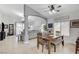 The bright dining room features tile floors, a long wood table with grey upholstered chairs, and views to the living room at 8250 Lincoln Valley St, Las Vegas, NV 89123