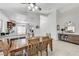 Open dining area with wood table, tile flooring and seamless flow to the kitchen, great for entertaining at 8250 Lincoln Valley St, Las Vegas, NV 89123
