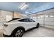 Spacious two-car garage showcasing a sleek vehicle and ample storage at 8250 Lincoln Valley St, Las Vegas, NV 89123