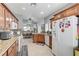 Kitchen with granite counters, wood cabinets and modern appliances at 8250 Lincoln Valley St, Las Vegas, NV 89123