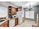 Charming kitchen with granite countertops, stainless steel appliances and a modern chandelier at 8250 Lincoln Valley St, Las Vegas, NV 89123