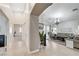 Open-concept living room with tile flooring, chandelier, and access to the backyard at 8250 Lincoln Valley St, Las Vegas, NV 89123