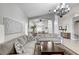 Cozy living room with tile floors and neutral walls, open to the dining area and kitchen at 8250 Lincoln Valley St, Las Vegas, NV 89123