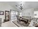 Open living room with tile floors, neutral decor, and a sliding glass door to the patio at 8250 Lincoln Valley St, Las Vegas, NV 89123