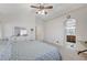 Spacious main bedroom with ceiling fan, dresser, and ensuite bathroom entrance at 8250 Lincoln Valley St, Las Vegas, NV 89123