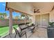 Relaxing outdoor patio with covered seating, ceiling fan, and privacy wall at 8250 Lincoln Valley St, Las Vegas, NV 89123
