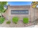 Community sign reading 'Hidden Crest III' surrounded by decorative bushes and desert landscaping at 8250 Lincoln Valley St, Las Vegas, NV 89123