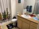 Bathroom with a vanity, a toilet with a patterned rug, and a shower with a curtain at 8250 N Grand Canyon Dr # 2154, Las Vegas, NV 89166