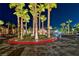 Night view of the entrance featuring a well-manicured island with mature palms and attractive landscaping at 8250 N Grand Canyon Dr # 2154, Las Vegas, NV 89166