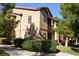Tan condo complex with maintained bushes, sidewalks, and greenery at 8250 N Grand Canyon Dr # 2154, Las Vegas, NV 89166