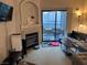 A well-lit living room featuring a fireplace and access to a balcony at 8250 N Grand Canyon Dr # 2154, Las Vegas, NV 89166