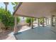 Charming covered back porch with ample seating and lush landscaping at 8847 W Katie Ave, Las Vegas, NV 89147