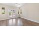 Bedroom with bright sliding glass doors, a ceiling fan and wood floors at 8847 W Katie Ave, Las Vegas, NV 89147