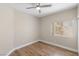 Neutral bedroom with a window providing natural light and wood floors at 8847 W Katie Ave, Las Vegas, NV 89147