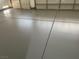 This garage has an epoxy floor and a three-car garage door for easy access at 8847 W Katie Ave, Las Vegas, NV 89147