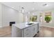 Well-lit kitchen with a large island featuring a sink, stainless steel appliances, and hardwood floors at 8847 W Katie Ave, Las Vegas, NV 89147