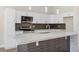 Modern kitchen featuring white cabinets, stainless steel appliances, and a large island with stone countertops at 8847 W Katie Ave, Las Vegas, NV 89147