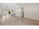 Bright living room with wood floors, high ceilings, and sliding door to the patio at 8847 W Katie Ave, Las Vegas, NV 89147
