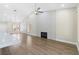 Open-concept living room featuring hardwood floors, a modern fireplace, and ample natural light from large windows at 8847 W Katie Ave, Las Vegas, NV 89147