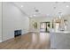 Spacious living area features modern fireplace, hardwood floors, and seamless access to the outdoor patio at 8847 W Katie Ave, Las Vegas, NV 89147
