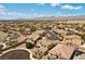 Panoramic aerial showcasing a thriving residential area with lush greenery and mountain vistas at 8953 Hitch Creek St, Las Vegas, NV 89131