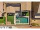 Aerial view of backyard featuring a pool, spa, patio, artificial turf, and fire pit at 8953 Hitch Creek St, Las Vegas, NV 89131