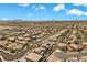 Wide aerial view showcasing a planned community with uniform housing and desert mountain views at 8953 Hitch Creek St, Las Vegas, NV 89131