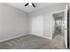 A well lit bedroom with neutral walls, light carpet and an open doorway to adjoining rooms at 8953 Hitch Creek St, Las Vegas, NV 89131