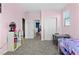 Bright bedroom features pink walls, grey carpet, and a window that provides natural light at 8953 Hitch Creek St, Las Vegas, NV 89131