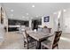 Spacious dining area adjacent to the kitchen, featuring stylish furnishings and tile flooring at 8953 Hitch Creek St, Las Vegas, NV 89131