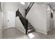 Welcoming foyer featuring tile floors, a staircase with dark railings, and neutral paint at 8953 Hitch Creek St, Las Vegas, NV 89131