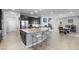 Open kitchen featuring a large island with seating, adjacent to the dining and living area at 8953 Hitch Creek St, Las Vegas, NV 89131